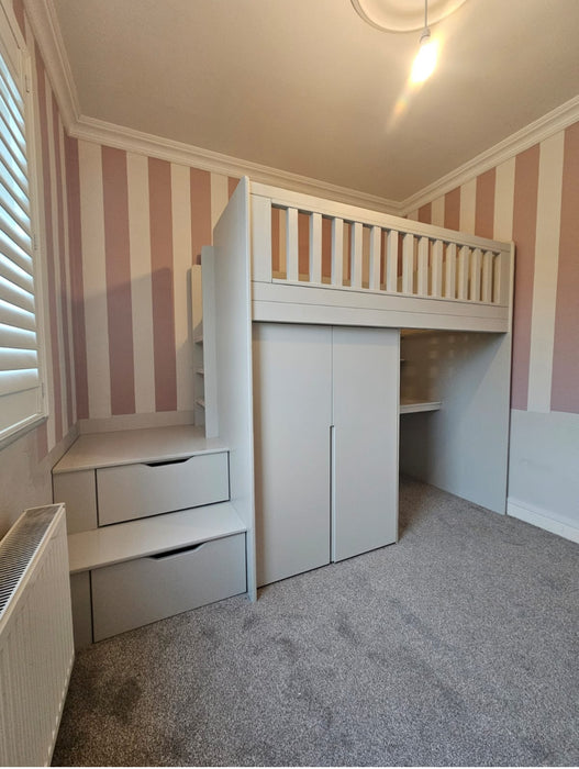 Children's room with a white loft bed, desk, and storage drawers against striped walls.