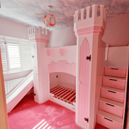 Children's castle bunk bed in pink with a slide, drawers, and two towers.