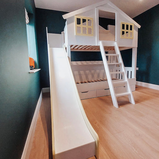 Children's clubhouse bunk bed with a slide, hand-painted shutters, and a slide in a room with green walls.