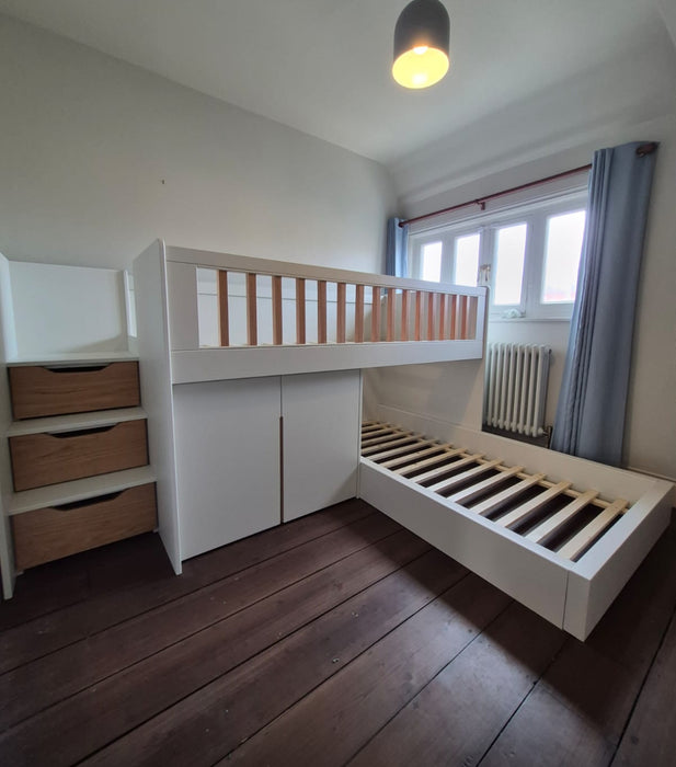 White loft bed with wooden accents in a room with a radiator and window.
